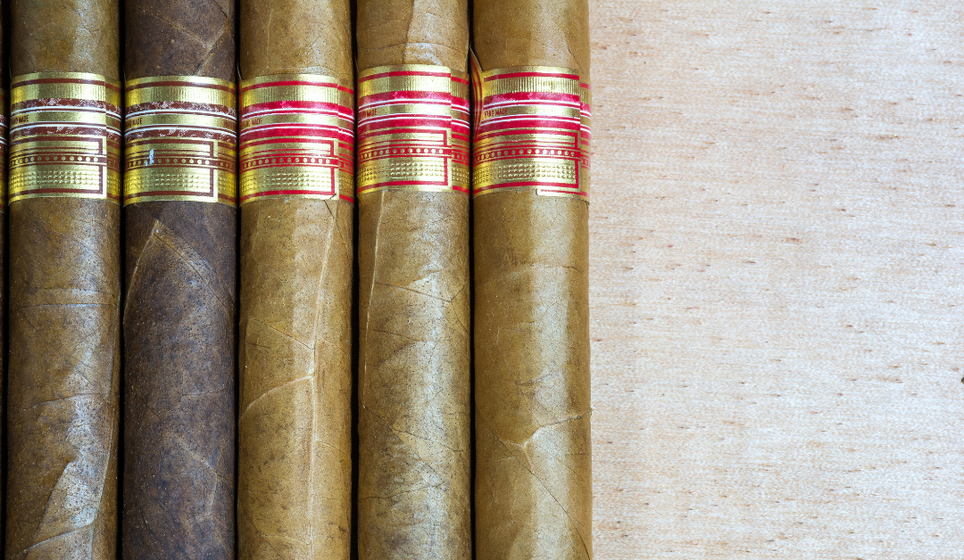 image of six cigars three dark three light with a white background